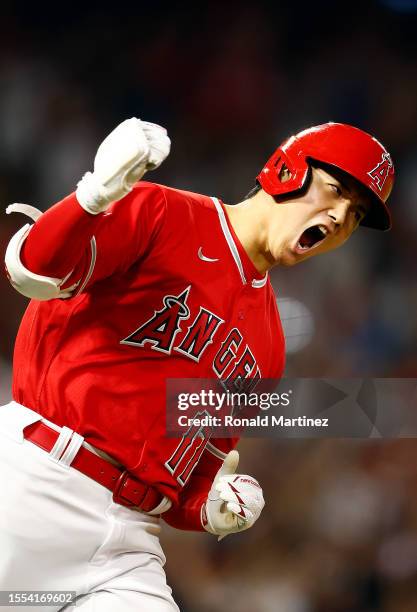 Shohei Ohtani of the Los Angeles Angels reacts after hitting a two-run home run against the New York Yankees in the seventh inning at Angel Stadium...