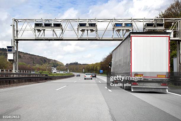 trucks and cars on german highway, toll system gantry - toll stock pictures, royalty-free photos & images