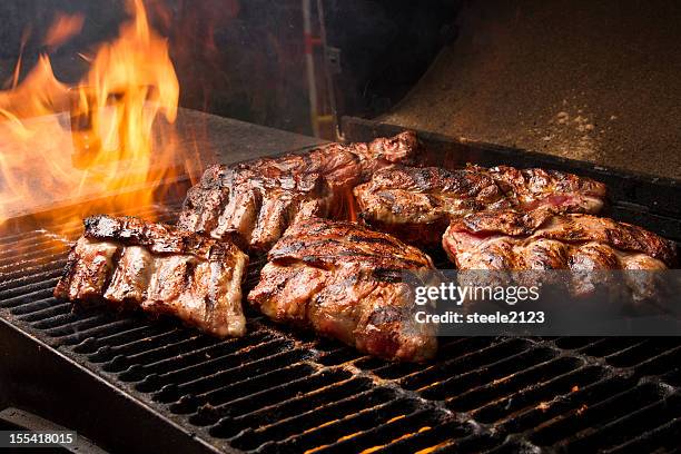 ribs on a grill - grill fire meat stockfoto's en -beelden