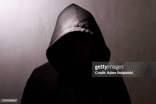 man with hidden face - hooded shirt stock pictures, royalty-free photos & images