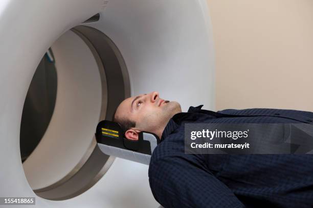 man having a medical examination via mri scan - x rays broken back stock pictures, royalty-free photos & images