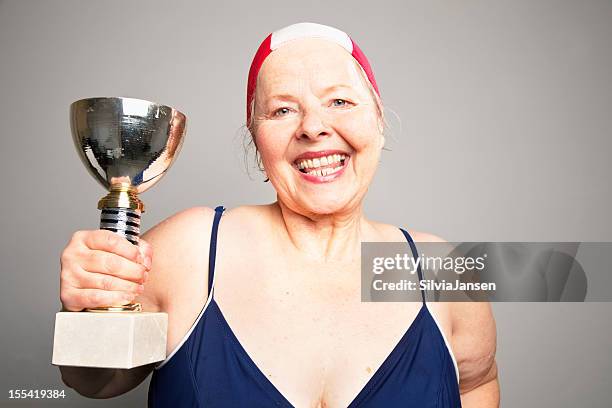 overweight senior woman winner swim trophy - old woman in swimsuit stock pictures, royalty-free photos & images