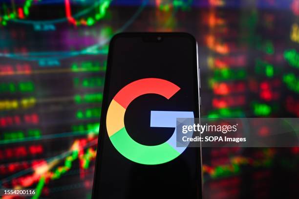 In this photo illustration a Google logo is displayed on a smartphone with stock market percentages in the background.