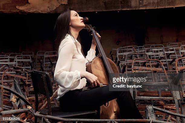 cello playing cellist musician - beautiful woman violinist stock pictures, royalty-free photos & images