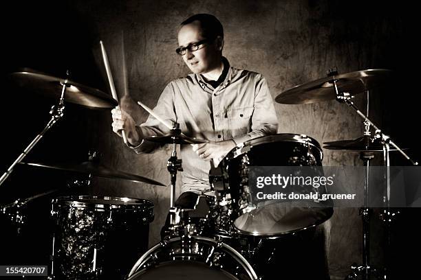 male drummer playing drumset with motion blur - drummer stock pictures, royalty-free photos & images