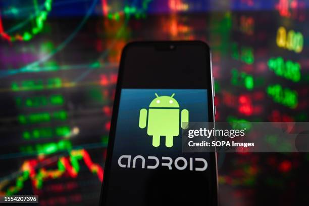 In this photo illustration an Android logo is displayed on a smartphone with stock market percentages in the background.