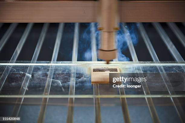 laser engraving machine cuting out text pattern - laser engraving stock pictures, royalty-free photos & images