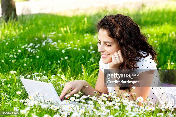 young woman with laptop in the park - laptop netbook stock pictures, royalty-free photos & images