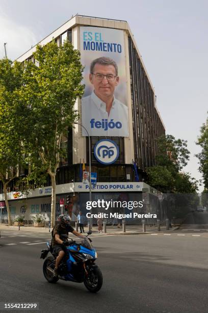 Large advertisement of PP with a portrait of candidate Alberto Núñez Feijóo covers the iconic facade of the party's headquarters on Génova Street...