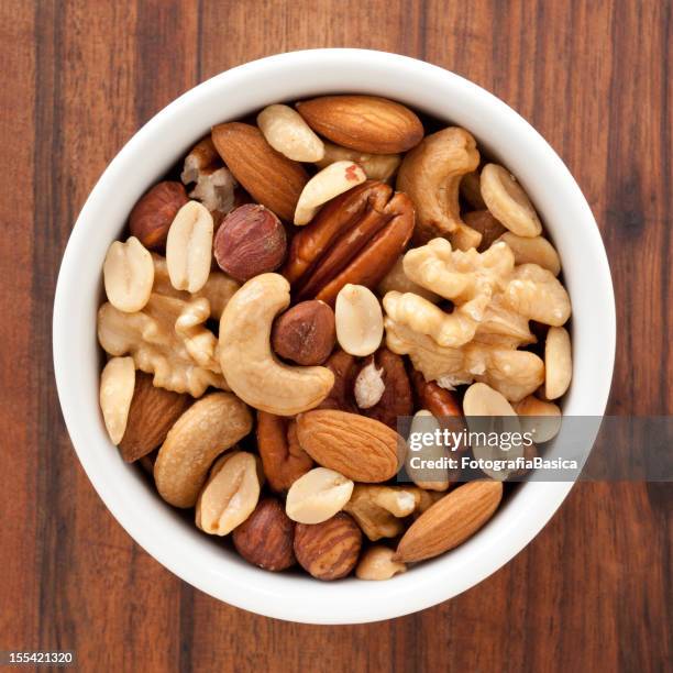 mixed nuts - dry fruits in bowl stock pictures, royalty-free photos & images