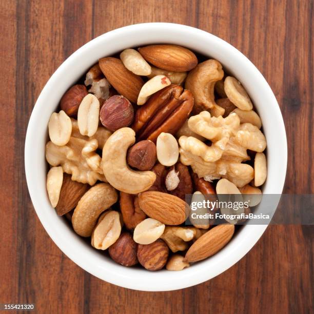 mixed nuts - dried stock pictures, royalty-free photos & images