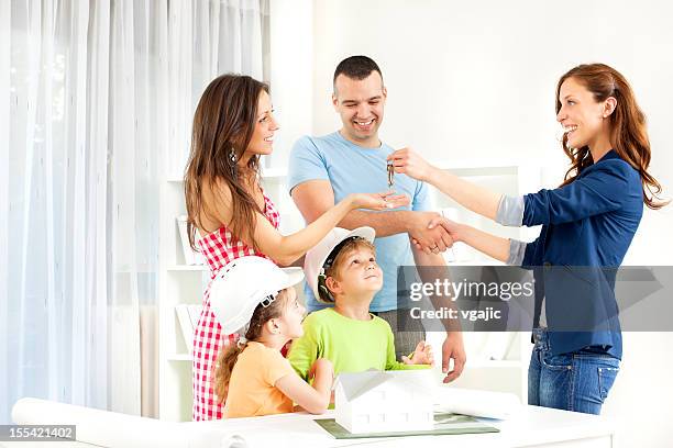 family meeting with real estate agent. - home key stockfoto's en -beelden