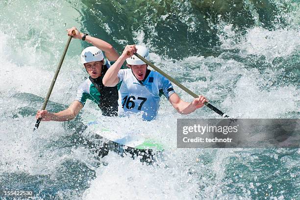 canoe team in whitewater mist - slalom stockfoto's en -beelden