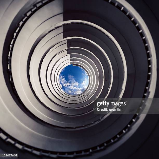 old spiral stairway from below - spiral staircase stock pictures, royalty-free photos & images