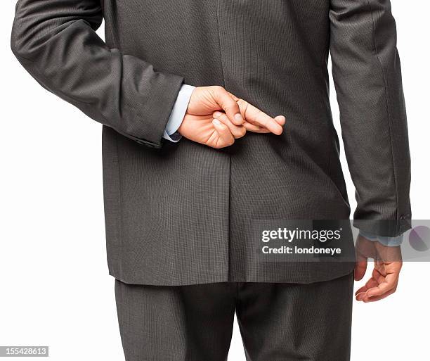 businessman crossing fingers behind his back - isolated - hands behind back stockfoto's en -beelden