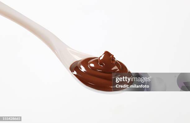 a white spoonful of chocolate mousse - chocolate sauce stock pictures, royalty-free photos & images