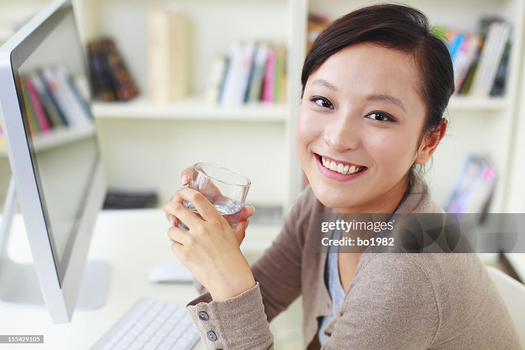 Pretty young woman working with computer in home