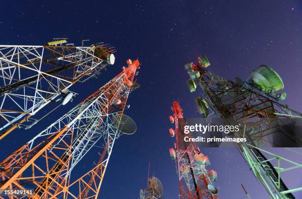 five telecommunication towers under a night sky  - clear channel stock pictures, royalty-free photos & images