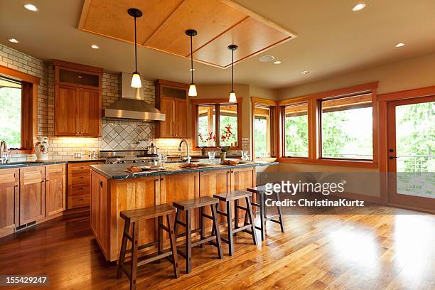 open-plan kitchen with wooden cabinets and walnut floor - kitchen hardwood floor stock pictures, royalty-free photos & images