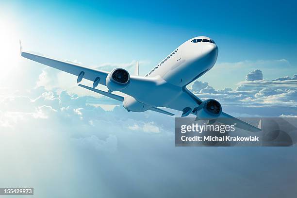 passenger jet airplane over clouds - aircraft stockfoto's en -beelden