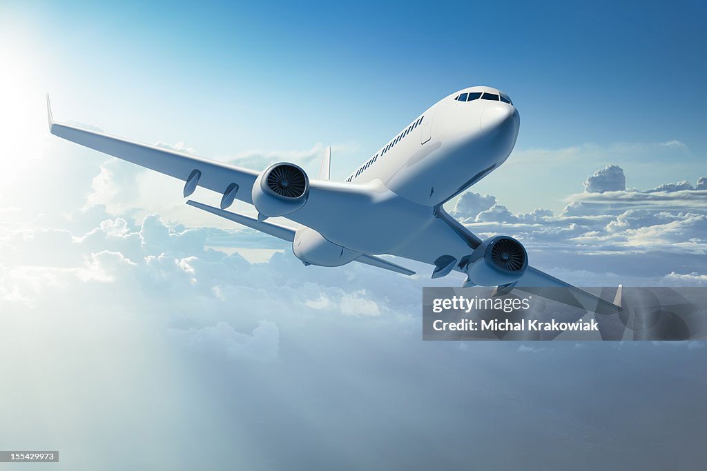 Passenger jet airplane over clouds