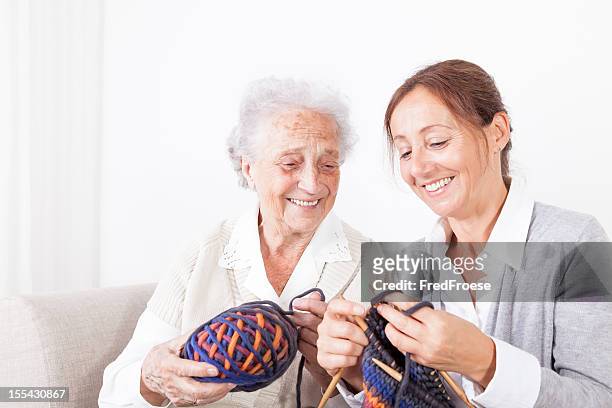 senior woman and caregiver - old granny knitting stock pictures, royalty-free photos & images