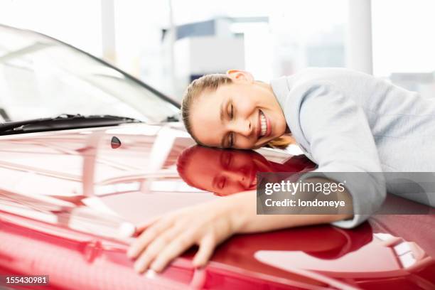 young woman embracing her new car - i love my customers stock pictures, royalty-free photos & images