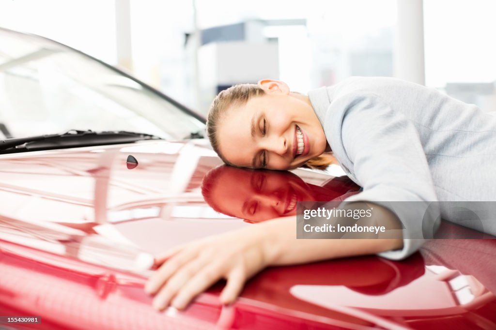 Young Woman Embracing Her New Car