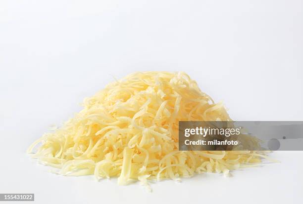 a heap of grated yellow cheese - grated stock pictures, royalty-free photos & images