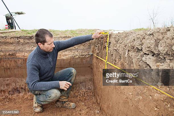 archaeologist using foot measure - archaeology stock pictures, royalty-free photos & images