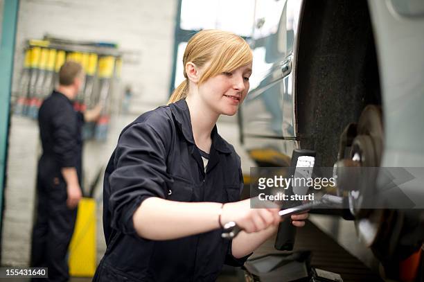 teenage girl working on a car wheel - open end spanner stock pictures, royalty-free photos & images