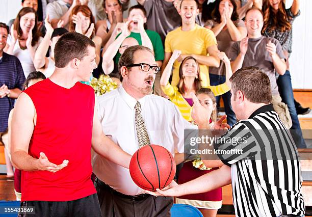 basketball game argument in front of crowd - referee shirt stock pictures, royalty-free photos & images