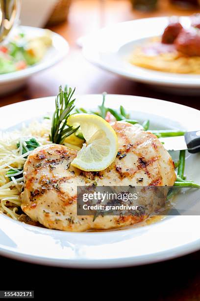 grilled chicken and pasta - lemon chicken stock pictures, royalty-free photos & images