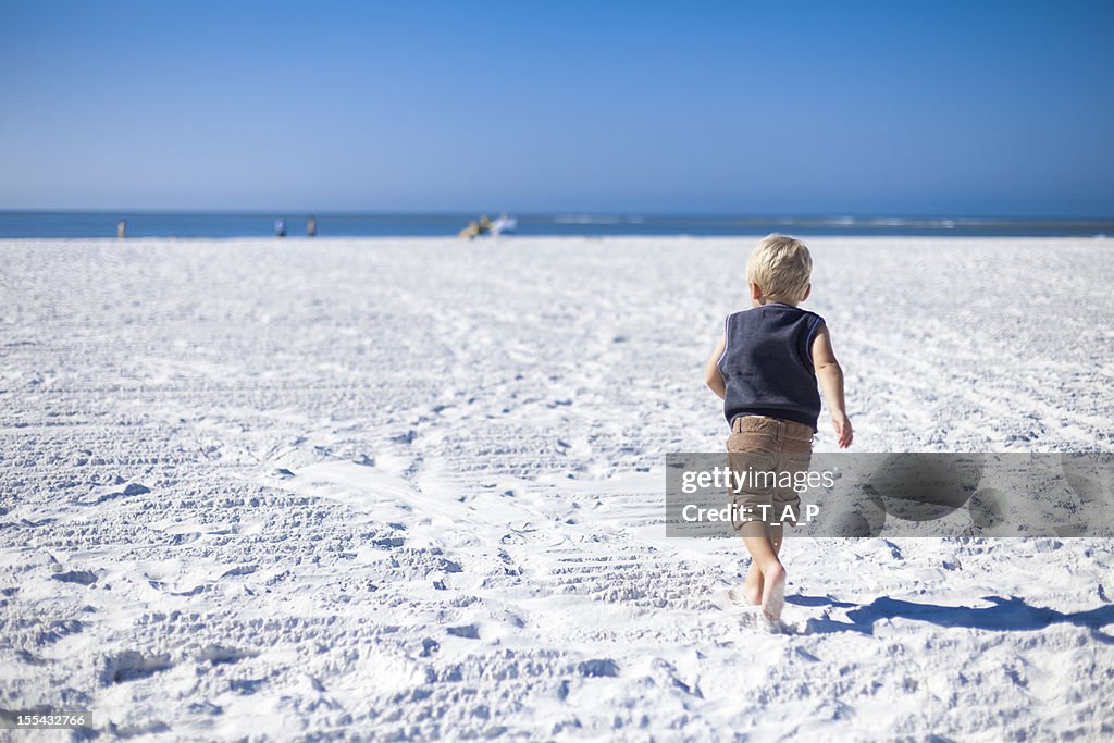 Young child running at beach