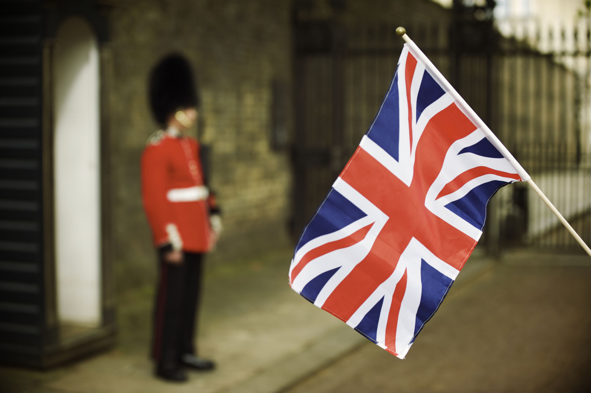 Union Jack Flag Waves Next to Soldier in Red Union Jack Flag Waves Next to Soldier in Red
