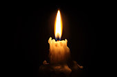 Bright waxy candle burns down