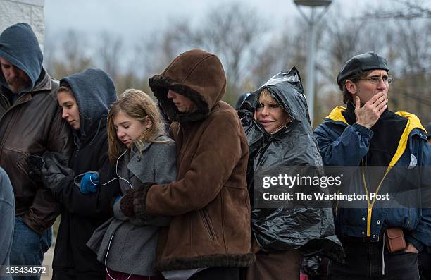 Braving the cold weather, Don, Madeline, Marilyn and Michelle Moyer and Justine Ovsenik wait in line to see President Barack Obama in Mentor, Ohio,...