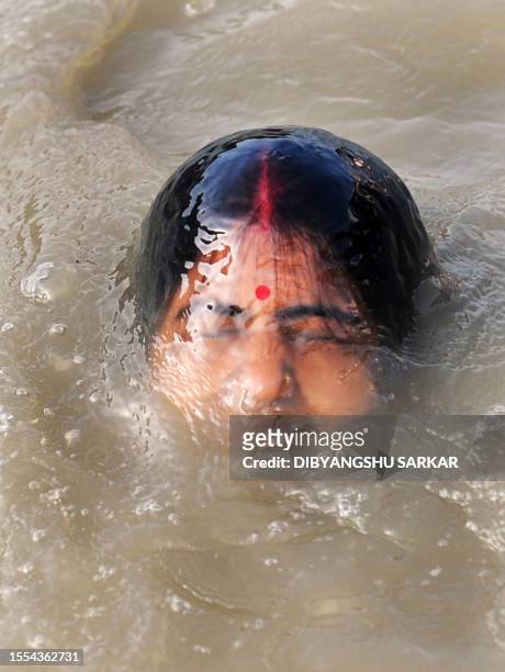 An Indian Hindu devotee performs "Tarpan", a ritual to pay obesience to ones forefathers, on the last day of "Pitrupaksh" - days for offering prayers...