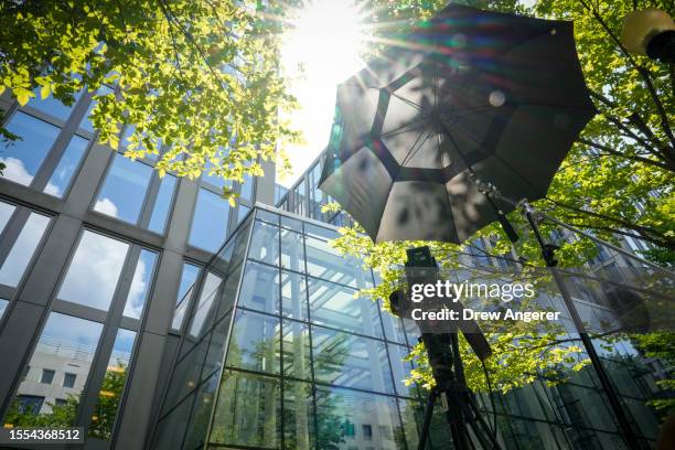 Television camera is pointed to a U.S. Department of Justice building that houses the office of Special Counsel Jack Smith July 25, 2023 in...