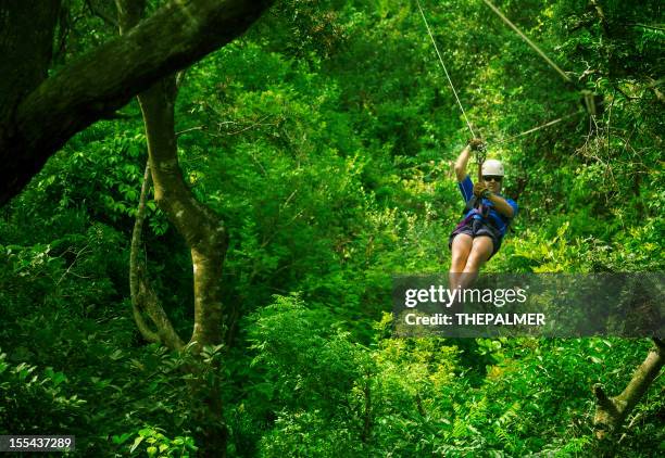 man during a canopy tour costa rica - costa rica zipline stock pictures, royalty-free photos & images