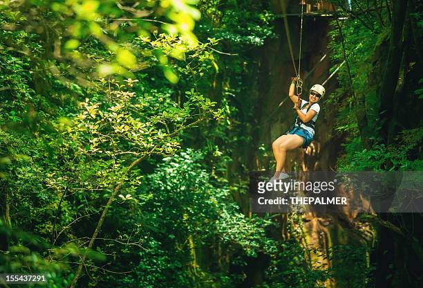 woman during a canopy tour costa rica - costa rica stock pictures, royalty-free photos & images