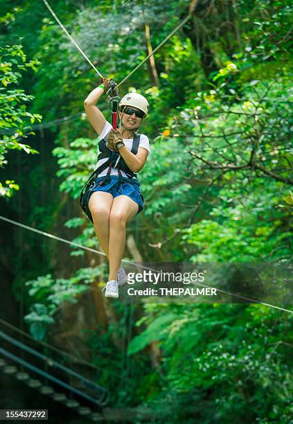 woman during a canopy tour costa rica - costa rica zipline stock pictures, royalty-free photos & images