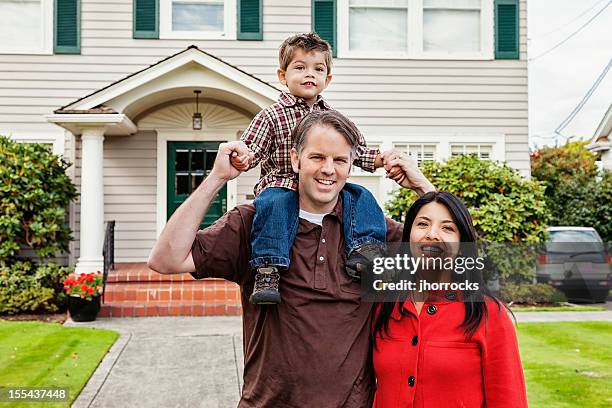 young mixed race family of three at home - family smiling at front door stock pictures, royalty-free photos & images