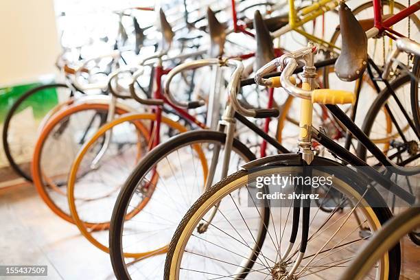 bicycles parked in a bike shop - bike shop stockfoto's en -beelden