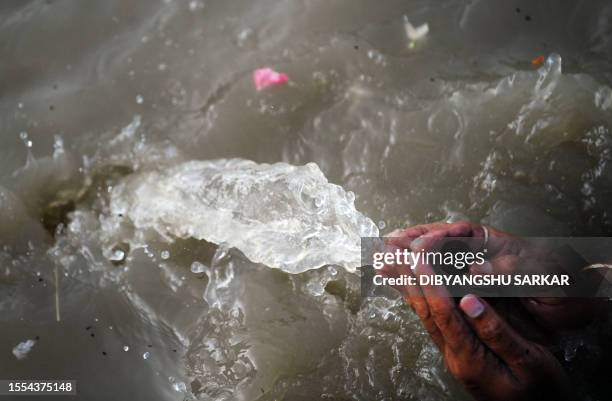 An Indian Hindu devotee performs "Tarpan", a ritual to pay obesience to ones forefathers, on the last day of "Pitrupaksh" - days for offering prayers...