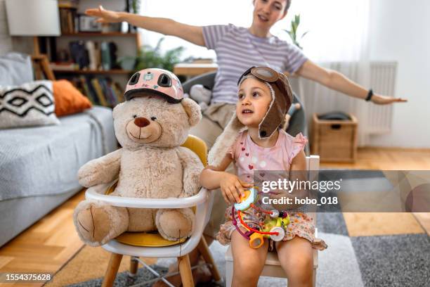 toddler girl and her mother playing pilots at home - aviator glasses stock pictures, royalty-free photos & images