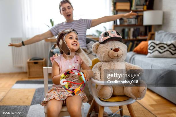 toddler girl and her mother playing pilots at home - aviator glasses stock pictures, royalty-free photos & images