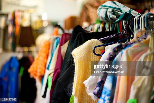 a used clothing rack at a thrift store - förvaringsställ bildbanksfoton och bilder