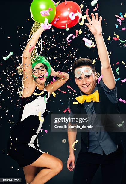 couple celebrating new years day, party or carnival, balloons, confetti - balloon fiesta stock pictures, royalty-free photos & images