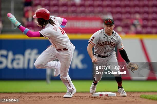 Casey Schmitt of the San Francisco Giants chases after Elly De La Cruz of the Cincinnati Reds during a rundown in the ninth inning at Great American...